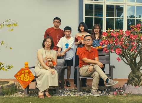 A joyful family gathering outdoors with decorations, reflecting togetherness and celebration.
